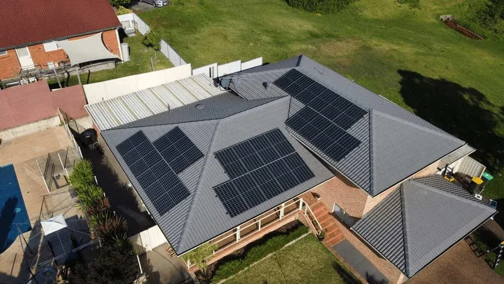 Aerial view of a family home with a large rooftop solar array